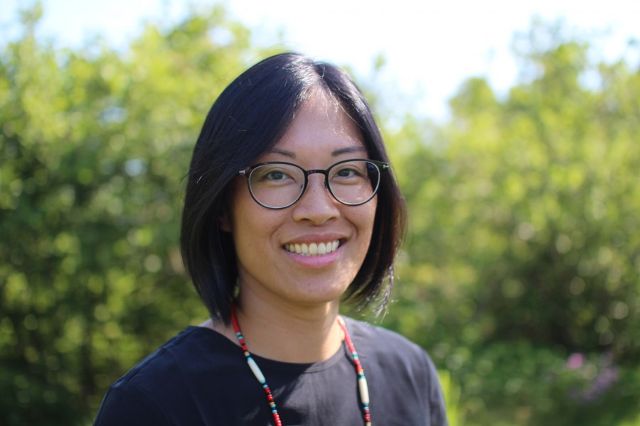 A smiling woman with glasses and dark hair 