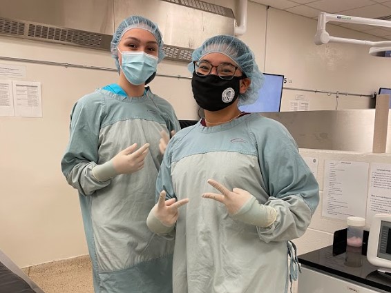 Aliyah Aglukkaq (right) poses with her friend and fellow camper Anikan Ikuallaq-Pouliot in a gowning, gloving, and suturing session during AVC Vet Camp. 