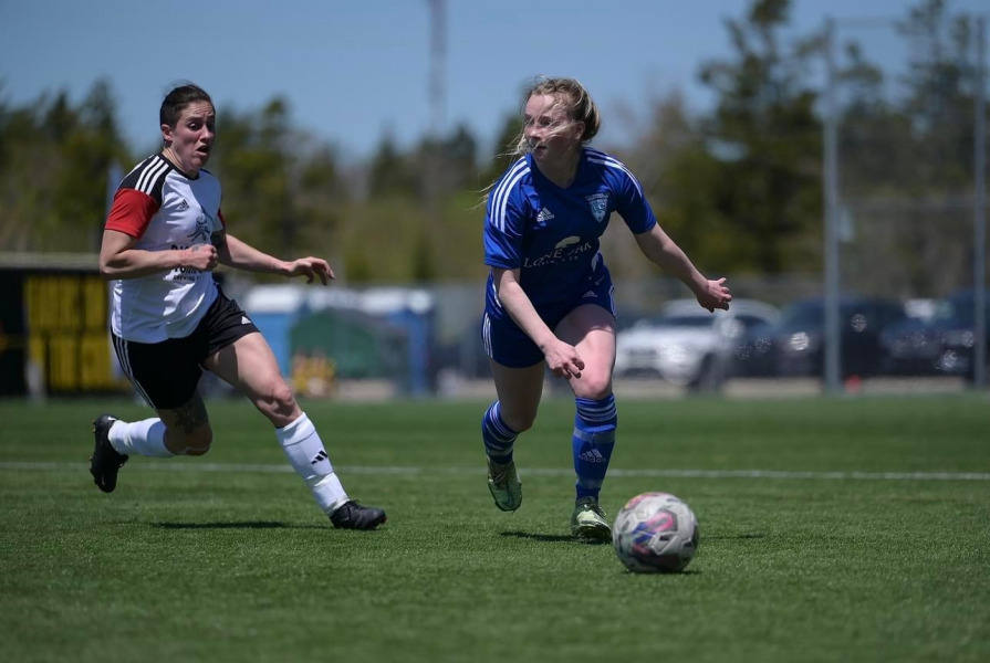 New Panther recruit Olivia James (right) surveys the field before clearing the ball to safety.