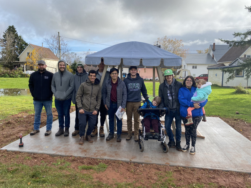 From left: UPEI Faculty of Sustainable Design Engineering team members Andrew Townsend (FSDE technician), William Craine (SAT), Nathan Belanger (SAT), Jimmy Hulton (SSA), Ibrahim Hassan (SAT), Tin Nguyen (ESC coordinator), and Zac Mella (SSA), and Alexander MacKenzie MacDonald (Wish Child), Kyle MacKenzie (father), and Jocelyn Young (step-mother) holding Ellie MacKenzie (sister).