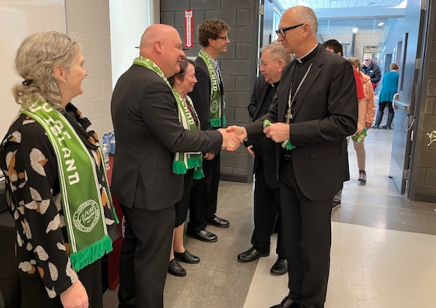 photo of man shaking hand with another man in receiving line