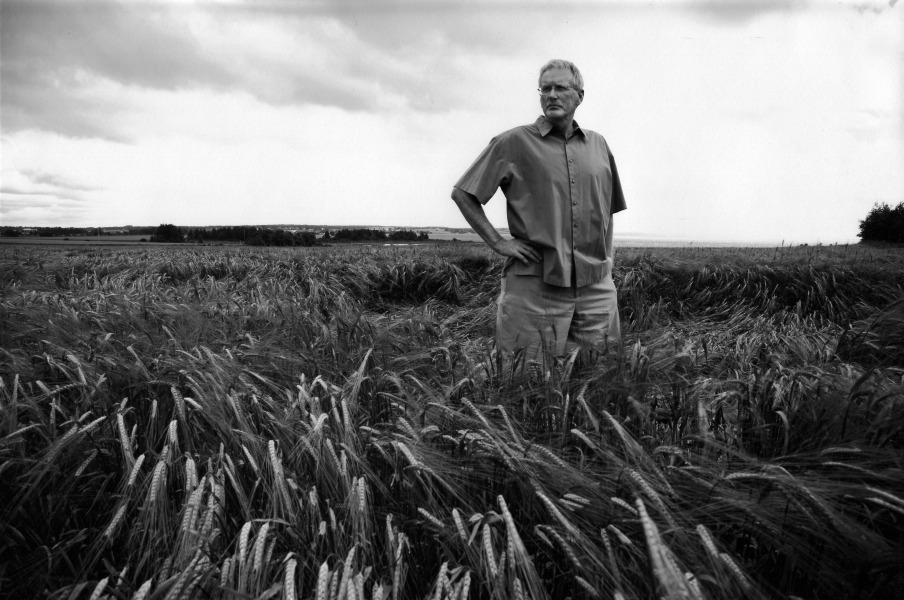 Dr. Brent MacLaine standing in field. Photo by John Sylvester