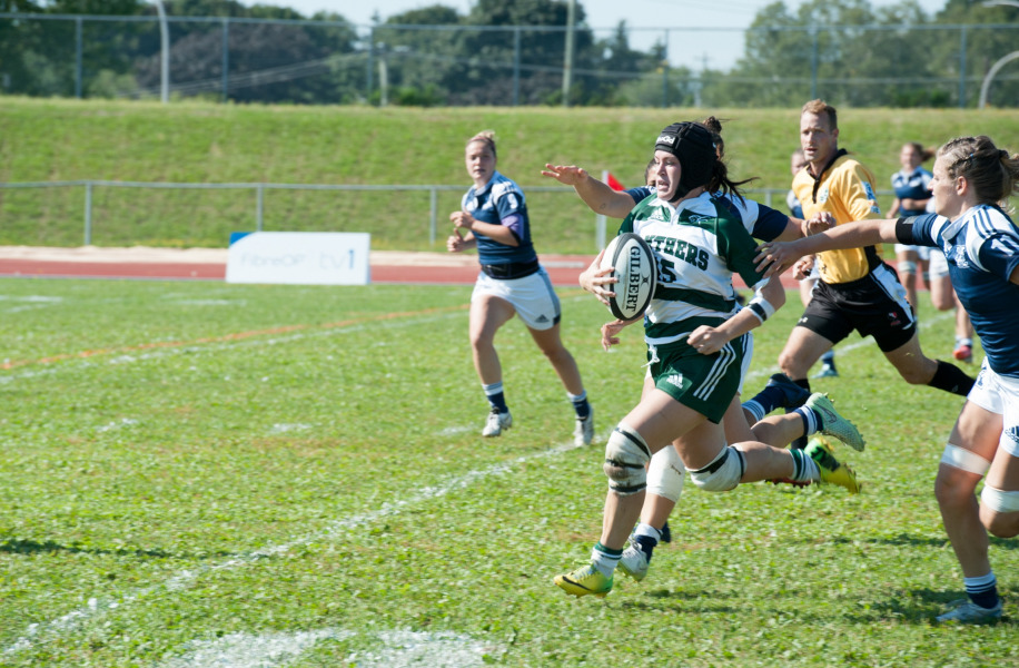 Alysha Corrigan carries the ball during a rugby match while she was a student-athlete at UPEI