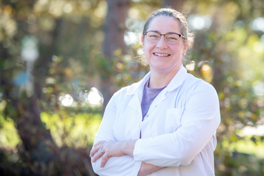 Photo of woman wearing white coat.