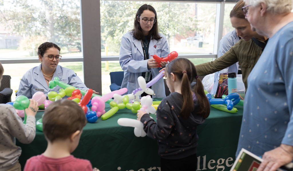 Students make balloon animals at the AVC Open House