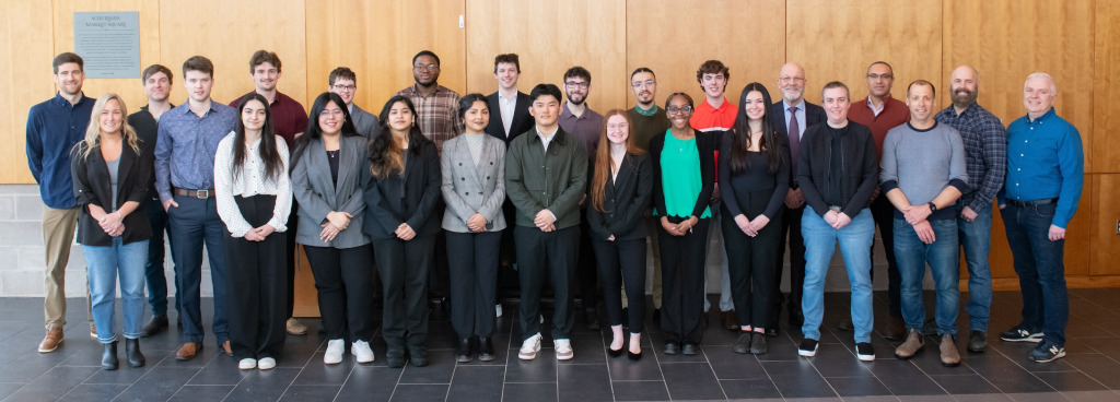 Four BUS-3910 student teams with representatives from UPEI Facilities Management, the Transportation and Parking Advisory Committee, and officials from the City of Charlottetown and the provincial government.