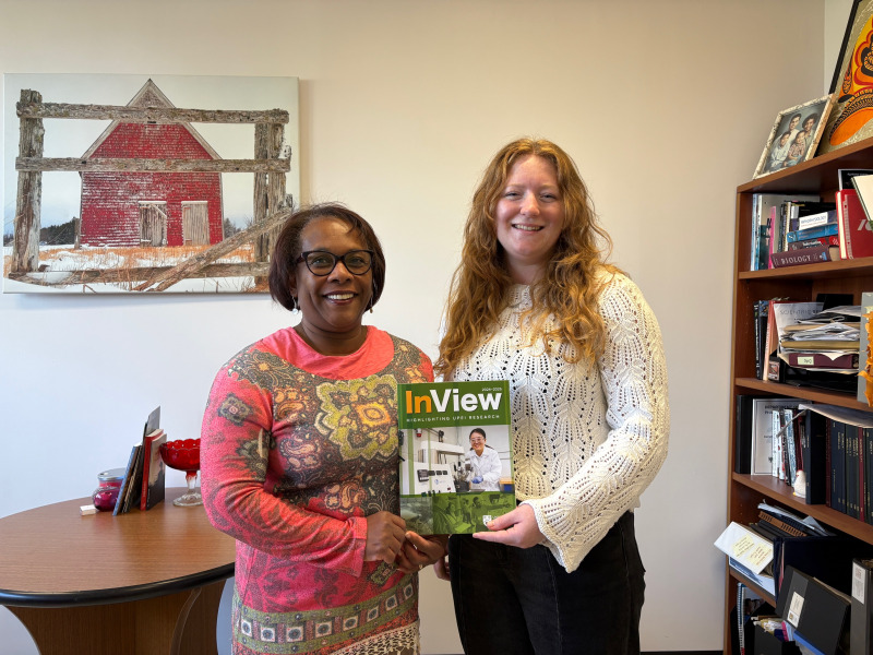 Two women holding magazine