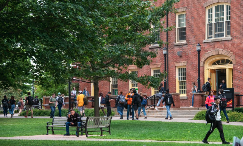 Photo of students walking in university quadrangle 