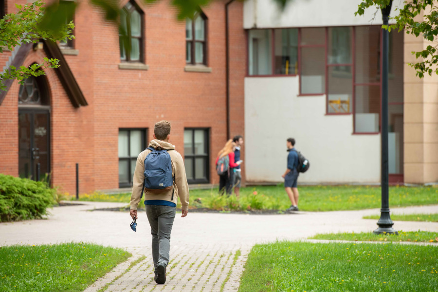 Student walking in the quad in spring