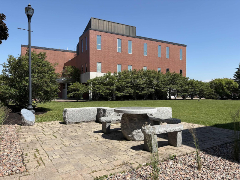photo of stone terrace with building in the background during summer