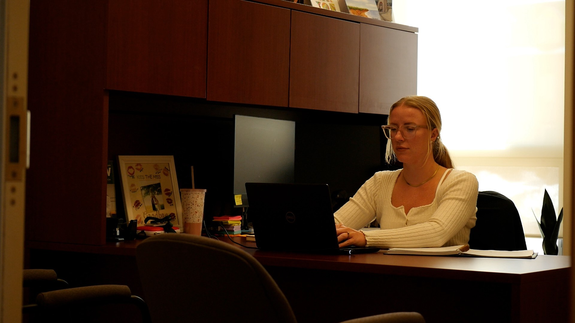 UPEI assistant professor Ashton Dougan in her office on a computer