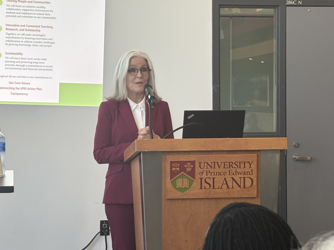 Woman delivering remarks from a podium