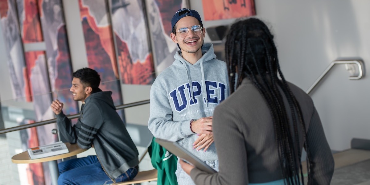 two students talking indoors