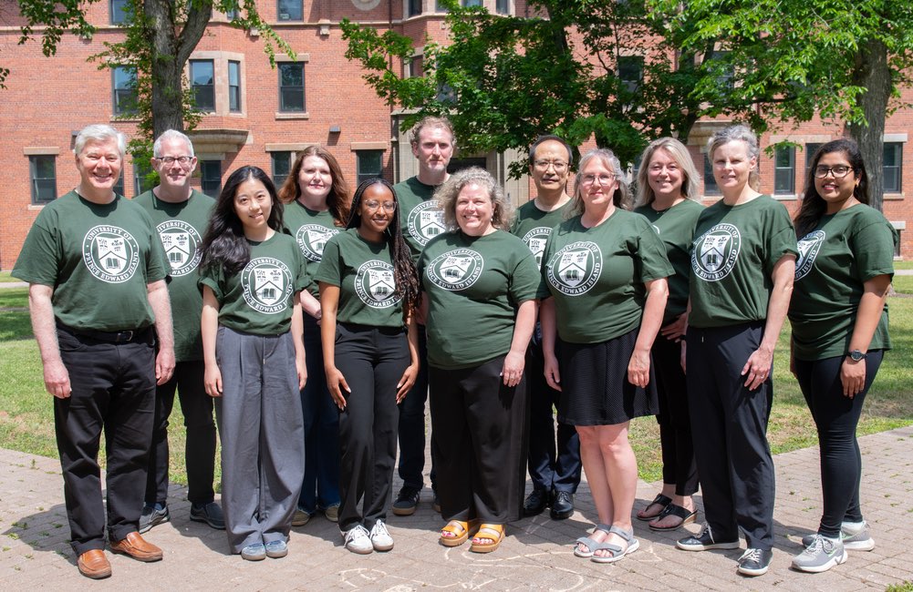 12 staff members of the UPEI International Relations Office in front of Dalton Hall
