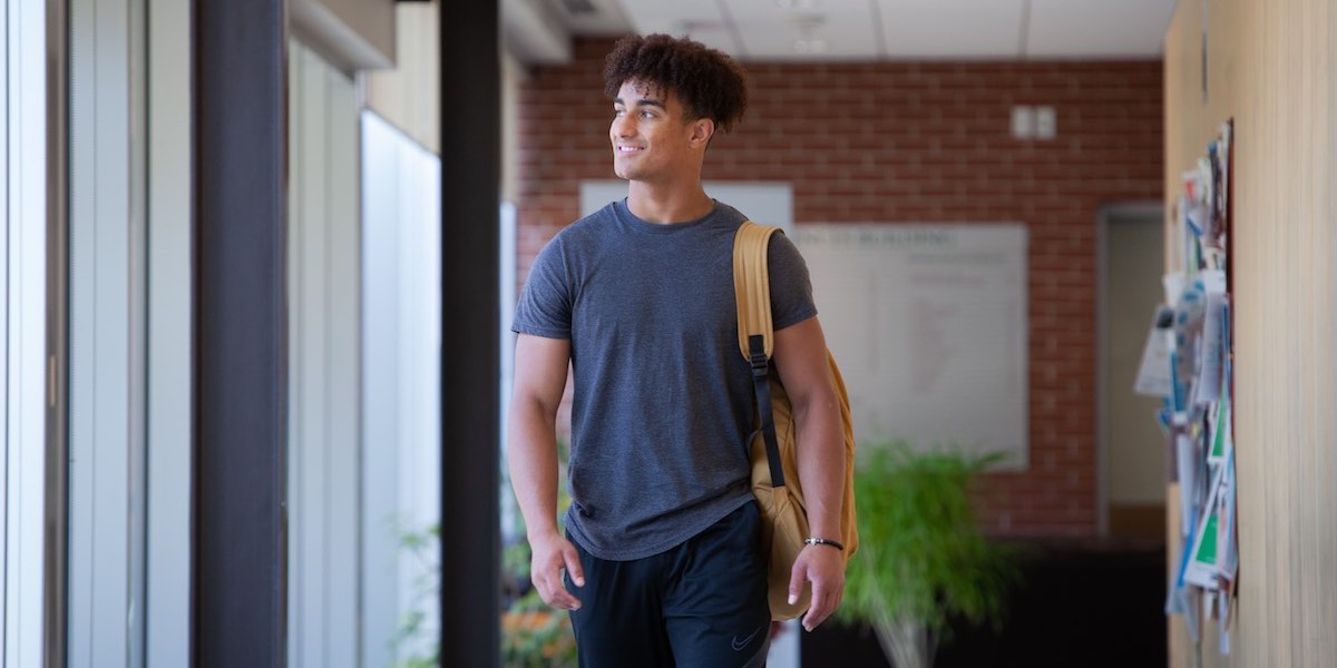 jeremy norman walking in a hallway in upei's health sciences building