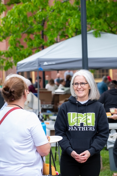 UPEI president Dr. Wendy Rogers speaking with colleagues in the UPEI quad