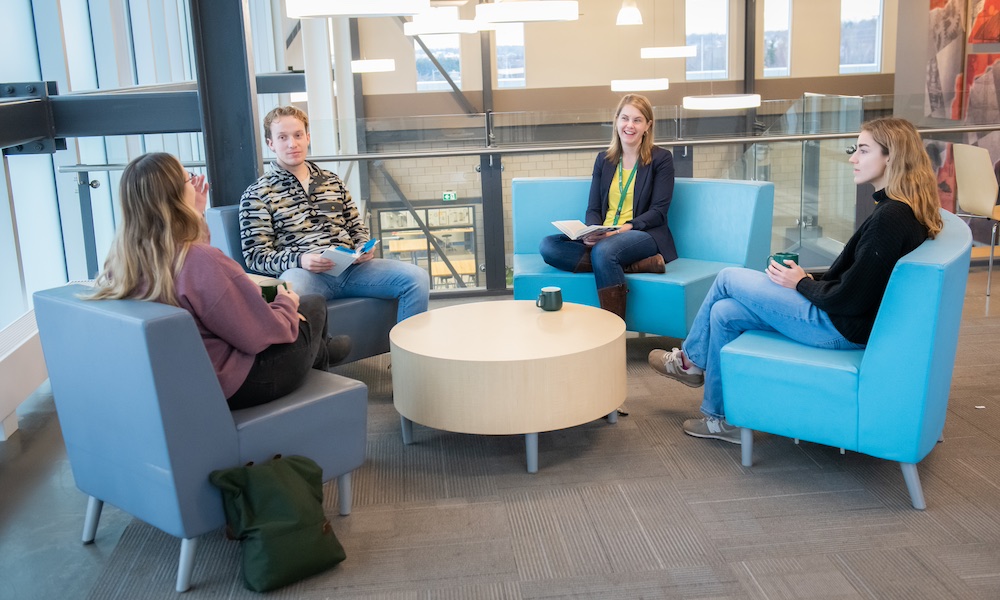 Dr. Stephanie Shaw with a group of three students