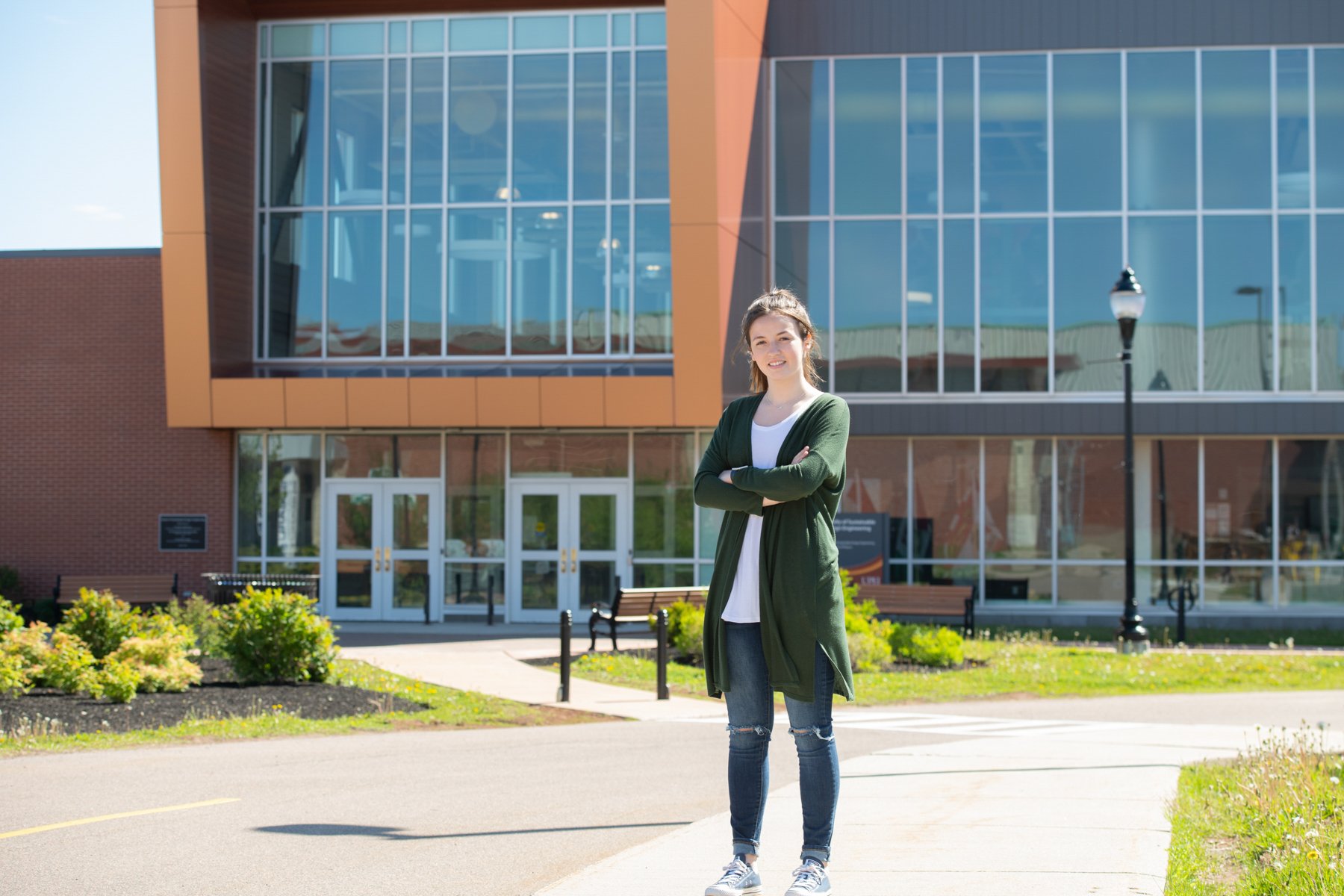 UPEI student Sydney Wheatley in front of the Faculty of Sustainable Design Engineering Building