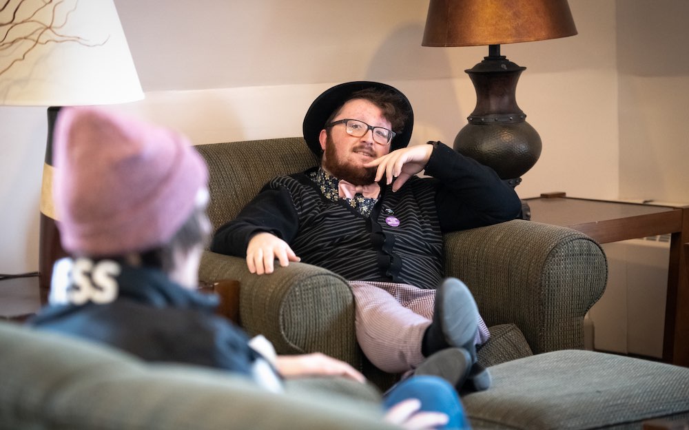 Tanner speaking with another student in a UPEI student lounge