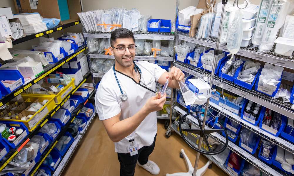 UPEI nursing student Gabriel in the supply room at the Queen Elizabeth Hospital