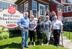 People stand in front of Bedford MacDonald House