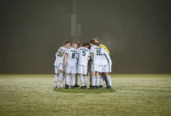 Soccer players huddle