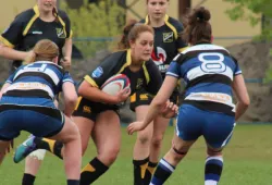 A group of young women playing rugby