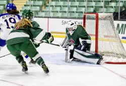 A goalie makes a save in an ice hockey game