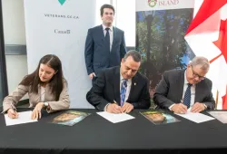 Signing a memorandum of understanding between UPEI and VAC are (left to right) Lisa Campbell, associate deputy minister, VAC; UPEI President and Vice-Chancellor Dr. Alaa Abd-El-Aziz; and the Hon. Lawrence MacAulay, Minister of VAC and Associate Minister of National Defence. Looking on is Devon Clark, student ambassador for UPEI and VAC.   