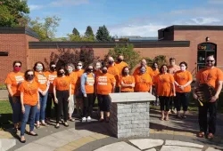 People wearing orange shirts for Orange Shirt Day