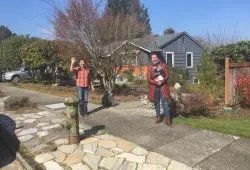 Two women stand on a suburban street