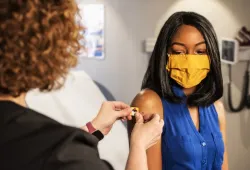 Image provided by CDC of a woman after receiving a COVID-19 vaccine administered by a health care professional