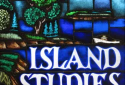 An image of a stained glass window scene of water, farmland, and sky with the words ISLAND STUDIES