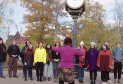 A small chamber choir sings outside on UPEI campus