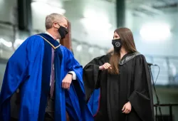 Dr. John VanLeeuwen congratulates new graduate Dr. Kaitlyn Williamson during UPEI's Convocation Ceremony.