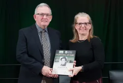 photo of man and woman holding plaque