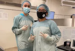 Aliyah Aglukkaq (right) poses with her friend and fellow camper Anikan Ikuallaq-Pouliot in a gowning, gloving, and suturing session during AVC Vet Camp. 