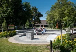 group of people sitting in outdoor amphitheatre during summer