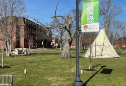 photo of tip and red brick building with banner 