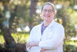 Photo of woman wearing white coat.