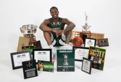 Kamari Scott poses with the awards he has earned throughout his six years at UPEI.