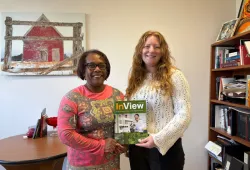 Two women holding magazine
