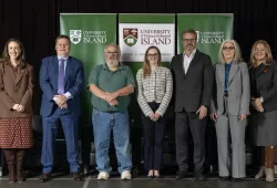 photo of group of people standing side by side on a stage
