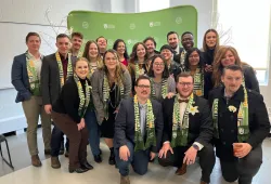 Large group of people standing in front of a photo backdrop