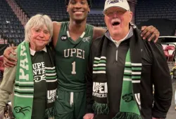 Marg and Steve Connolly celebrate UPEI’s 2025 AUS championship with Kamari Scott.