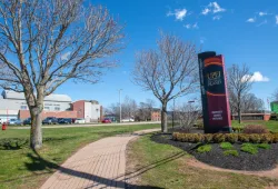 photo of sign in front of campus during spring