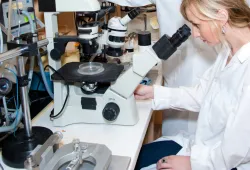 female biologist and microscope