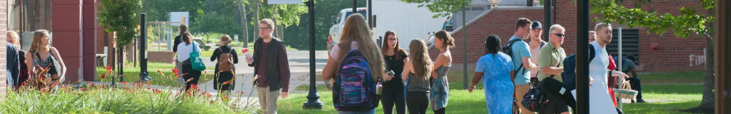 students in the quad in front of steel building 