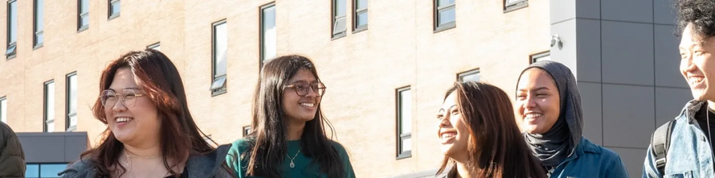 students walking in front of the UPEI performing arts centre and residence