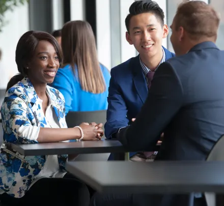 Students sit at a table talking